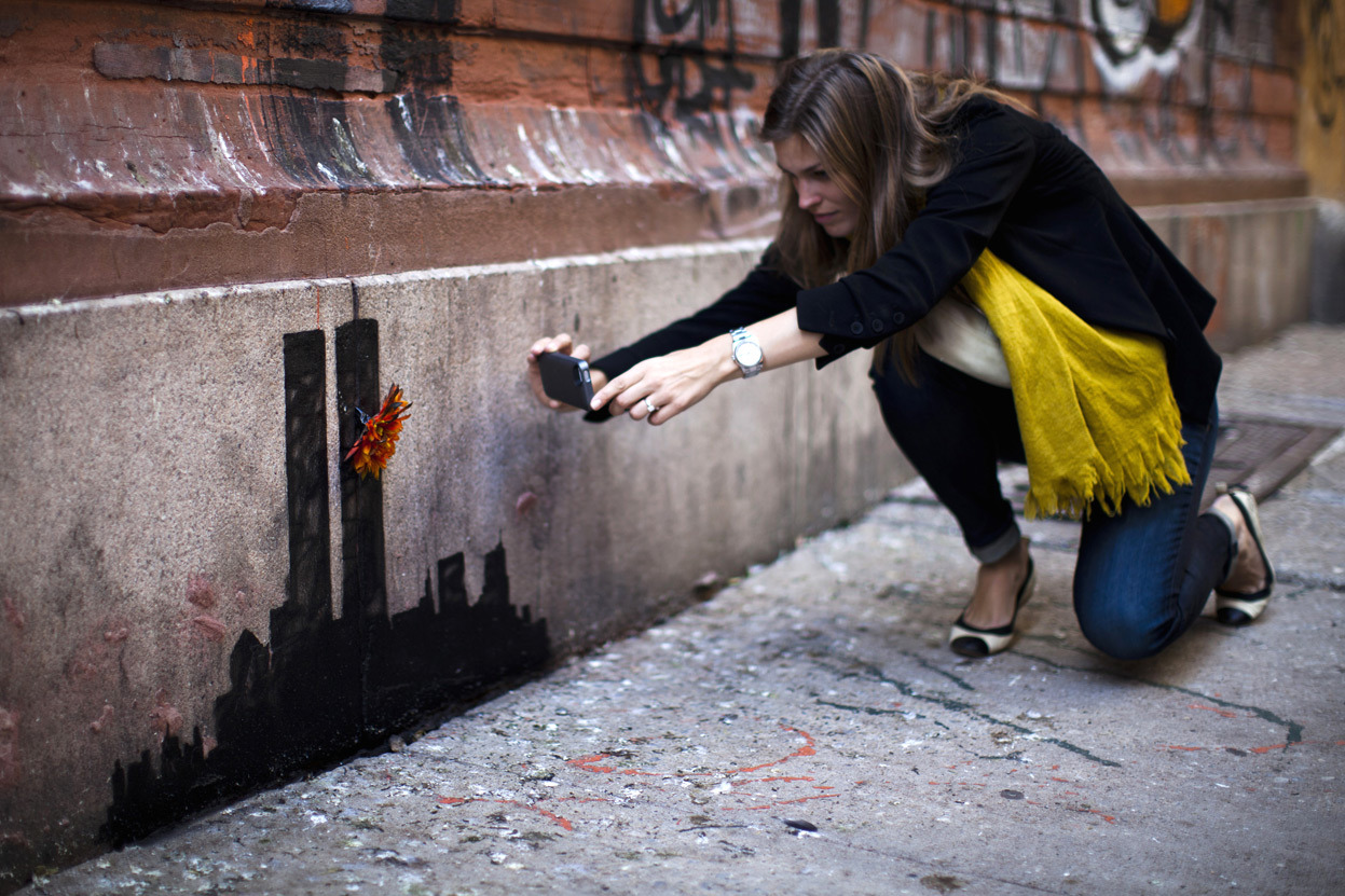 From Banksy in NYC, one of 23 photos. A woman takes a picture of an artwork by British graffiti artist Banksy in Lower Manhattan in New York City, on October 15, 2013. Art collectors and tourists in New York got a bargain during the weekend when...