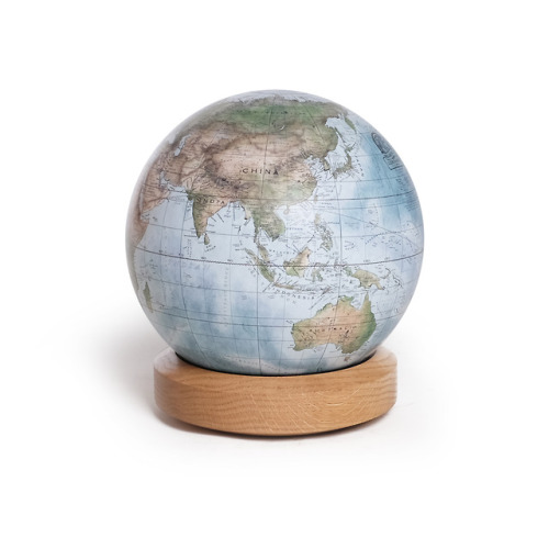 Earth from space! This style of globe is reminiscent of the famous Pale Blue Dot photograph. Painted