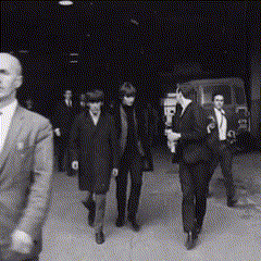 Arriving At The Scene For Their Interview "RoundUp" April 30, 1964 // John Looking Glum When Paul Asked