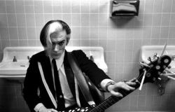 theunderestimator-2:  Bryan Gregory of The Cramps  ready to go on stage at  Pauley Ballroom of Berkeley University in 1979, as documented by Jonathan Postal, but only after having stuck cigarettes into his string ends to avoid the unthinkable danger of