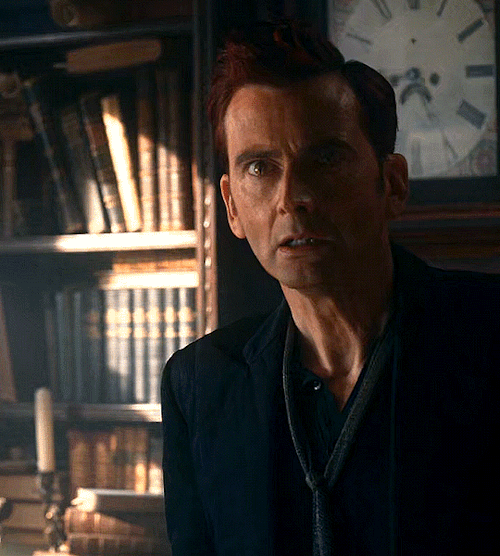 Gif 2/6: Crowley takes a step forward. His eyes are fixed on the person (Aziraphale) in front of him.