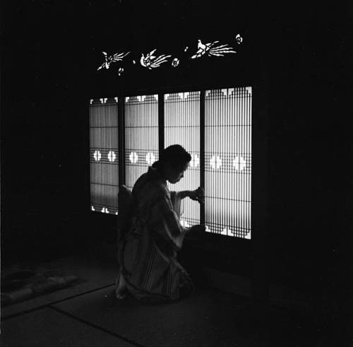 s-h-o-w-a: A maid closes the bamboo windows to a house on Hokkaido, the northernmost Island of Japan
