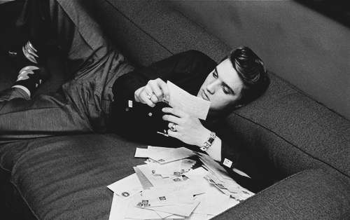 presley-elvis:  Elvis Presley reads fan mail at The Warwick Hotel, New York on March 4, 1956. Photographs taken by Alfred Wertheimer. 