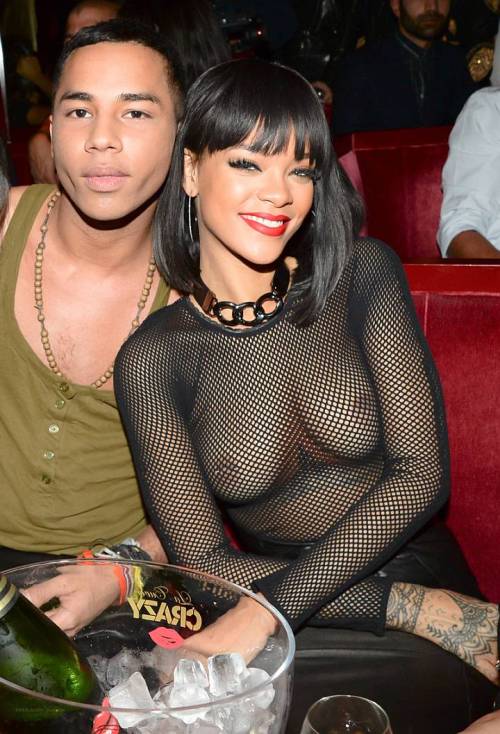 celebritynippleslips:  Rihanna topless in a see through mesh shirt at Paris Fashion Week