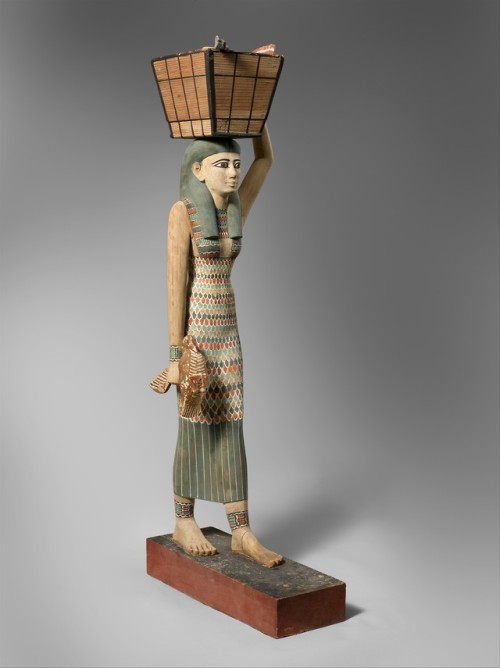 Ancient Egyptian wooden statuette from the tomb of Meketre at Thebes, depicting a woman bearing offe