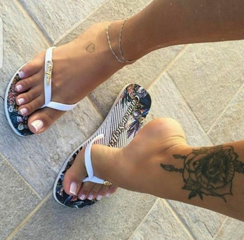 Pretty feet in cool looking flip flop sandals.