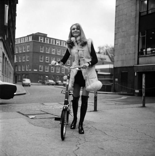isabelcostasixties: Model Blanche Webb wearing a fur jacket , riding a bicycle. London, November 196