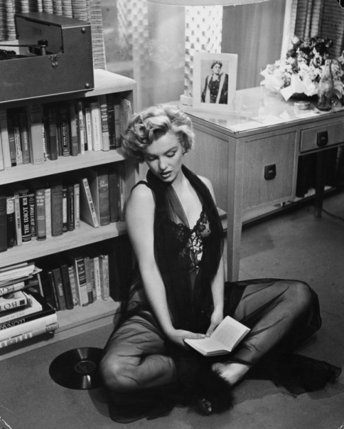 vintage-soleil:Marilyn Monroe at home listening to vinyl records in lingerie, 1952Photographed by Ph