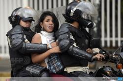thesmithian:   …anti-government activist arrested by national police during a protest in Caracas, Venezuela…  the robocop gear. the fear on her face. 
