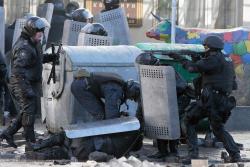 gunrunnerhell:  Back off… Riot police officers carry out an injured officer during clashes with protesters outside Ukraine’s parliament in Kiev, Ukraine, Tuesday, Feb. 18, 2014. Thousands of angry anti-government protesters clashed with police in