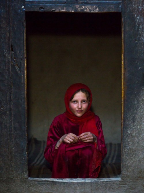 Portrait of an afghan girl with pale skin wearing red clothes, Badakhshan province, Khandood, Afghan