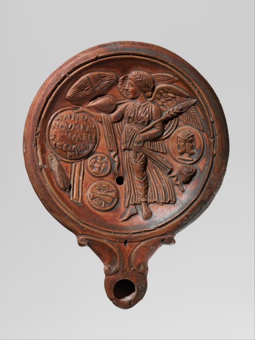 apuleiaprimilla:Terracotta oil lamp decorated on the discus with a winged Victory holding a shield, 