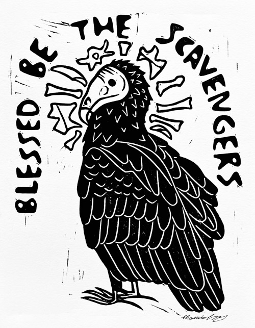 a black linocut print of a turkey vulture with a halo of small bones and teeth. in an arch over the vulture are the words 'blessed be the scavengers' in a blocky bubbly font