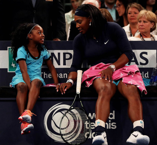 soph-okonedo:Serena Williams speaks to a young fan on the bench as she plays Caroline Wozniacki duri