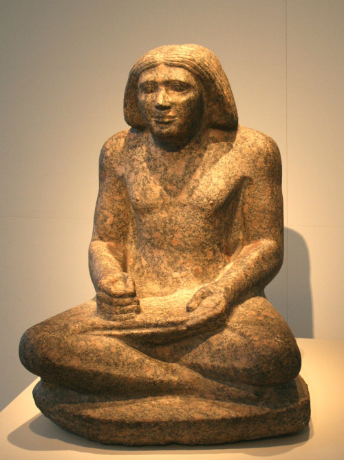 Statue of an ancient Egyptian scribe named Dersenedj, carved from red granite.  Artist unknown; ca. 