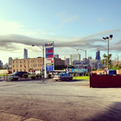 Pumping gas and enjoying the view. #myjob #mycity #mobilegas #instaphoto #clouds #tallbuildings