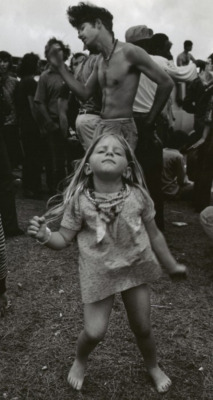  A young Hippie girl dancing at a festival