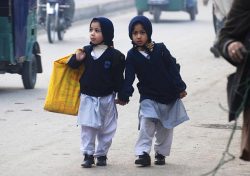 letswakeupworld:  Girls carry their school bags as they walk to their school after it reopened in Peshawar, Pakistan. 