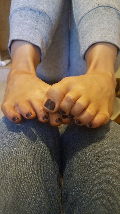 My pretty wife scrunching her toes on my lap while on her phone.please comment