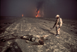 soldiers-of-war:    KUWAIT. Burgan oil fields. 1991. A US Marine inspects a charred corpse.Photograph: Bruno Barbey/Magnum Photos