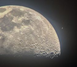  saturn as seen from behind the moon 