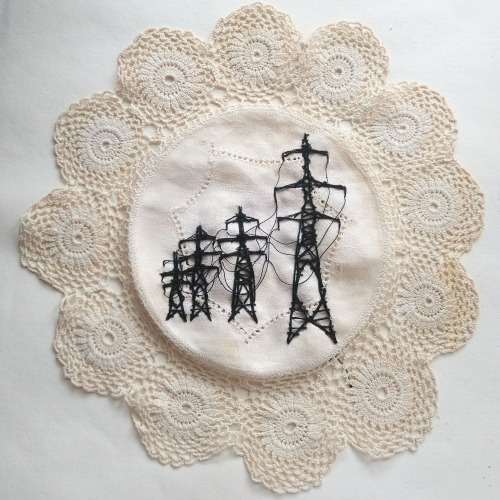 auntpelvis:embroidery of some electric pylons on an old doiley