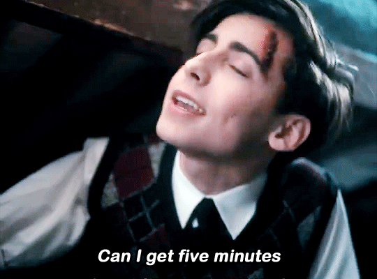 Gif of Number Five from the Umbrella Academy TV Show. It is a promo clip from Season 3. He leans to the side and, with a little smile on his face, faux-jovially says "Can I get five minutes?" 