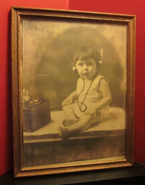 Vintage 1920’s Photo of Child with primitive hearing aid device.