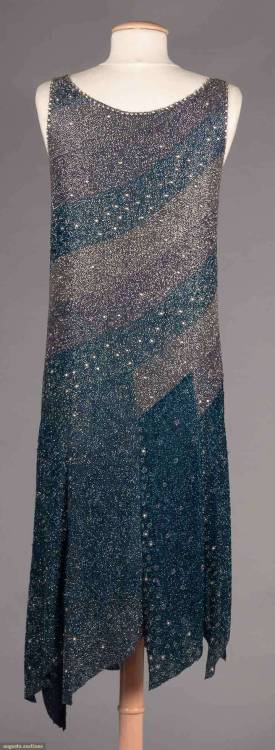 the1920sinpictures:1928 c. Blue and lilac diagonal beaded bands evening dress with an asymmetrical s