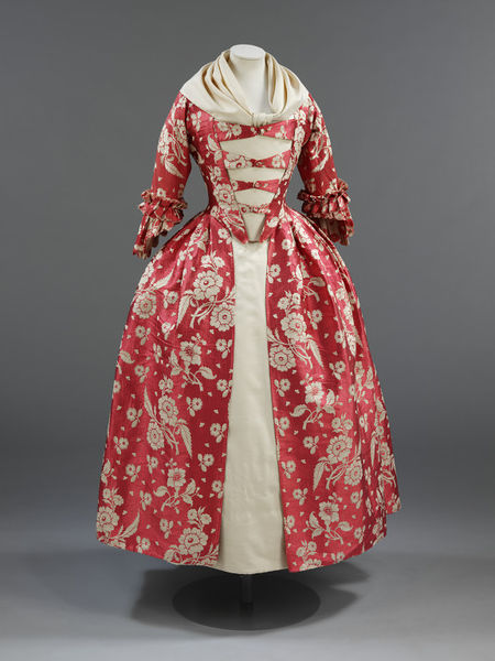 V&A: This 1760s gown features a rose-red silk with trails of ivory flowers woven in a complex te