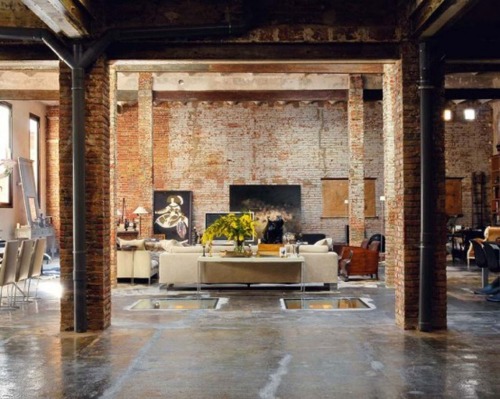 this modern loft in Barcelona uses brick walls and bare piping to create an industrial feel