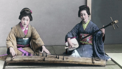 Hand-colored photo of two women playing the koto and shamisen.  Early 20th century (1900-1920), Japa