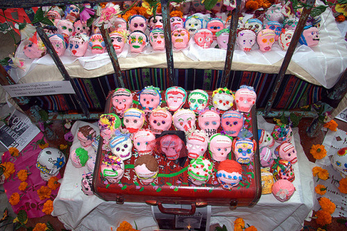 thomasbonar:  This ofrenda was constructed in remembrance of women killed along the Texas/Mexico border. There is one sugar skull for every women who has been found dead. Each skull has the name of one woman killed in the Juarez, Mexico area. Little has