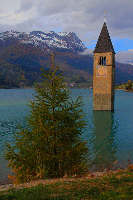 visitheworld:  The bell tower at Lago di Resia, South Tyrol / Italy (by Eifeelgood).
