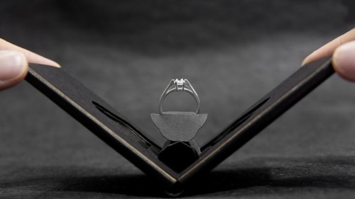 mymodernmet:  Andrew Zo designed the Clifton engagement ring box, a unique product that not only conceals the ring in a slim, wallet-size container before the big proposal, but also unfolds to show the ring pirouetting like a blooming flower. 