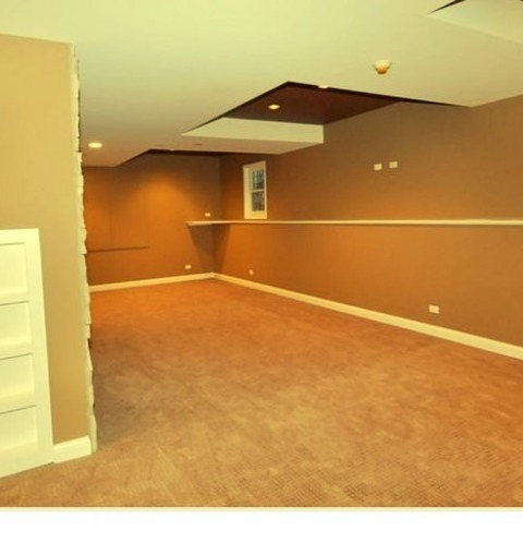 Lookout in Chicago
Example of a large minimalist look-out carpeted basement design with beige walls and no fireplace