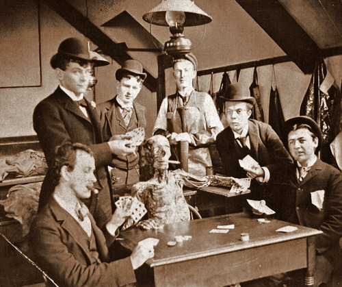 Medical students pose with a cadaver around, 1890.