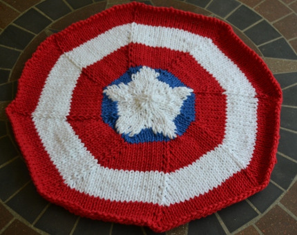 Spotted this. Could be good as a quick Christmas present knitting project (providing you’re proficient enough at knitting): a Captain America shield placemat. You can find the pattern for it over on craftbits.com.