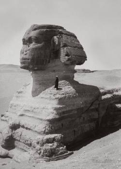 totenbuch:    A man standing on the Sphinx, demonstrating its size; 1900′s, in Giza, Egypt.
