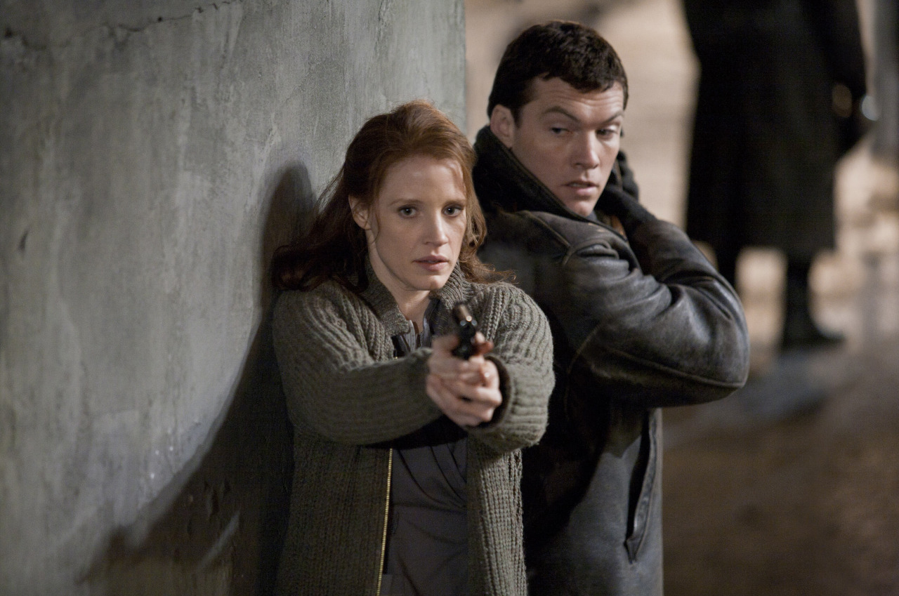 Laurie Sparham - Jessica Chastain and Sam Worthington in The Debt (L'Affaire Rachel