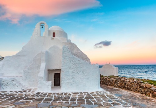 Rosy ☀️Church of Panagia Paraportiani at sunrise in Mykonos island. Photo by olgacov.View of Serifos