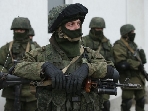 gunrunnerhell:  The Russians Heavily-armed soldiers without identifying insignia guard the Crimean parliament building after taking up positions there earlier in the day on March 1, 2014 in Simferopol, Ukraine. The soldiers’ arrival comes the day after