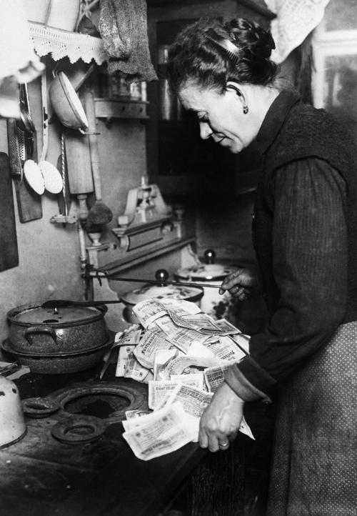 predecessors:A German woman burns paper money as fuel. Due to hyperinflation, cash was worth next to