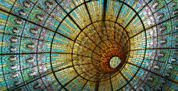 solarpunks:  Stained glass ceiling at the Palau de la Música Catalana, Barcelona (1908).  Though this photo is wonderfully ambiguous on the convex/concave front, the skylight does hang down into the room. That said, the idea of a stained-glass tunnel