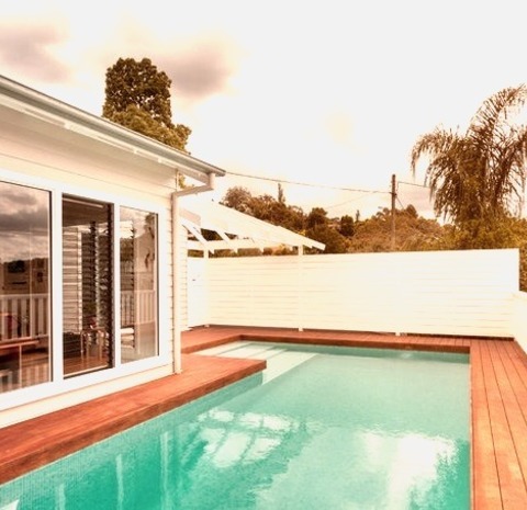 Beach Style PoolExample Of A Mid-sized Beach Style Rooftop L-shaped Aboveground Pool Design With Decking