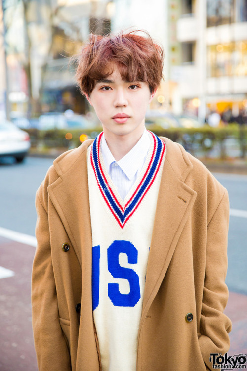 18-year-old Sohtaroh on the street in Harajuku wearing a tan coat over a v-neck sweater, tan cuffed 