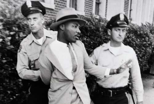 notevenpastuthistory:  Martin Luther King Jr. stands in front of a bus at the end of the Montgomery bus boycott. Montgomery, Alabama December 26, 1956. (Photo Credit: Time & Life Pictures/Getty Images) Martin Luther King Jr is arrested by two white