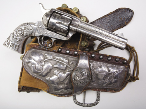 Engraved Colt Single Action Army with silver grips and Mexican silver mounted holster rig.Estimated 