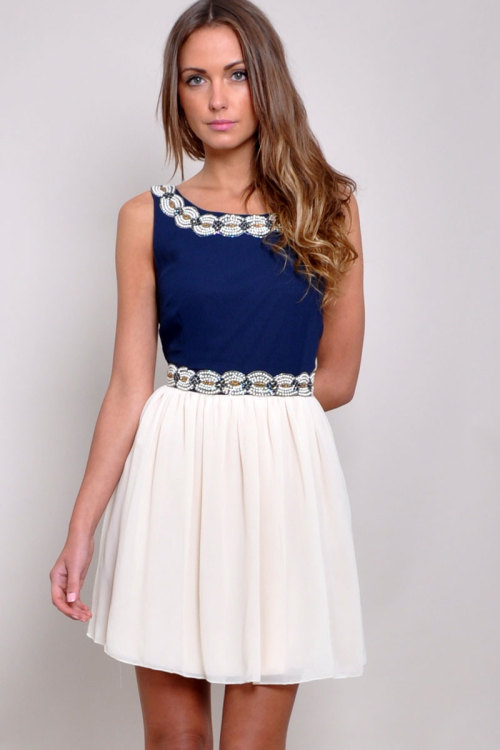 TFNC embellished neckline and waist dress with beaded pearl detailing.. Pleated skirt and concealed 