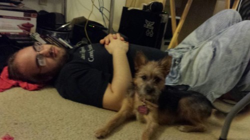 Corey passed out on the floor, dog decides to join in on the fun.